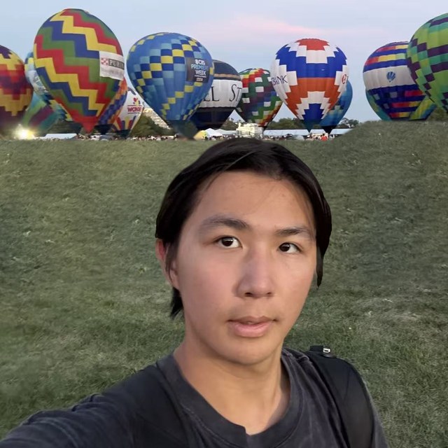 Leo Qin in front of hot-air balloons